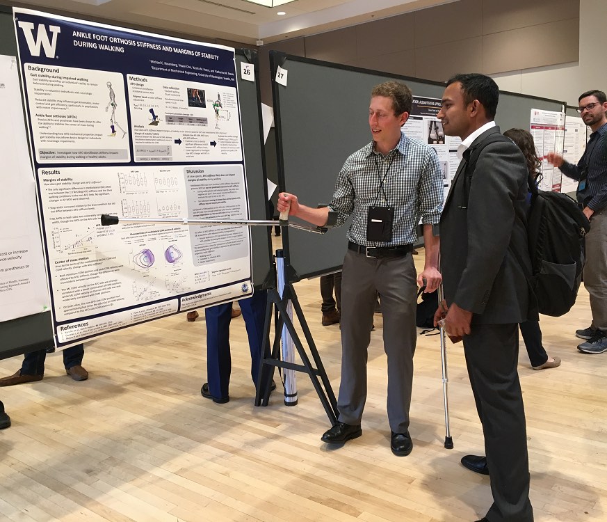 Michael Rosenberg walks through the results section of his poster with a fellow ASB member.