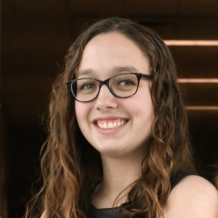 Nicole Zaino (wearing glasses) poses on campus