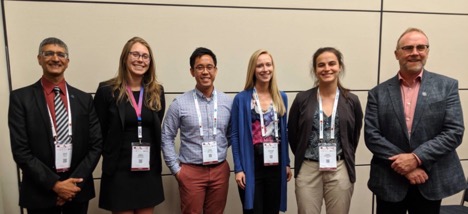 The ISPO student award winners for 2019 rehab week, including four students with Brandon in the middle, and the two main conference award organizers.