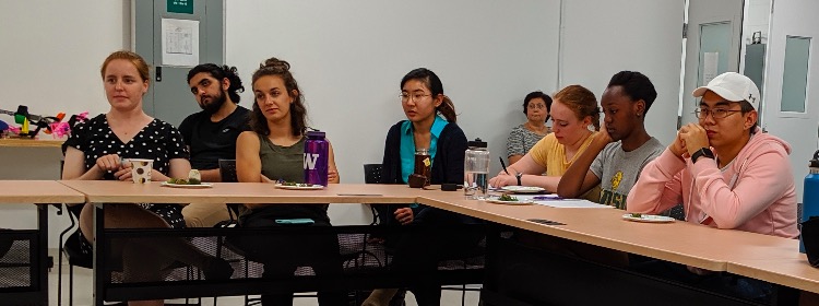 Students listen attentively to the Q&A Panel. Some look bored, some look amused, and one is even taking notes, or maybe doodling!